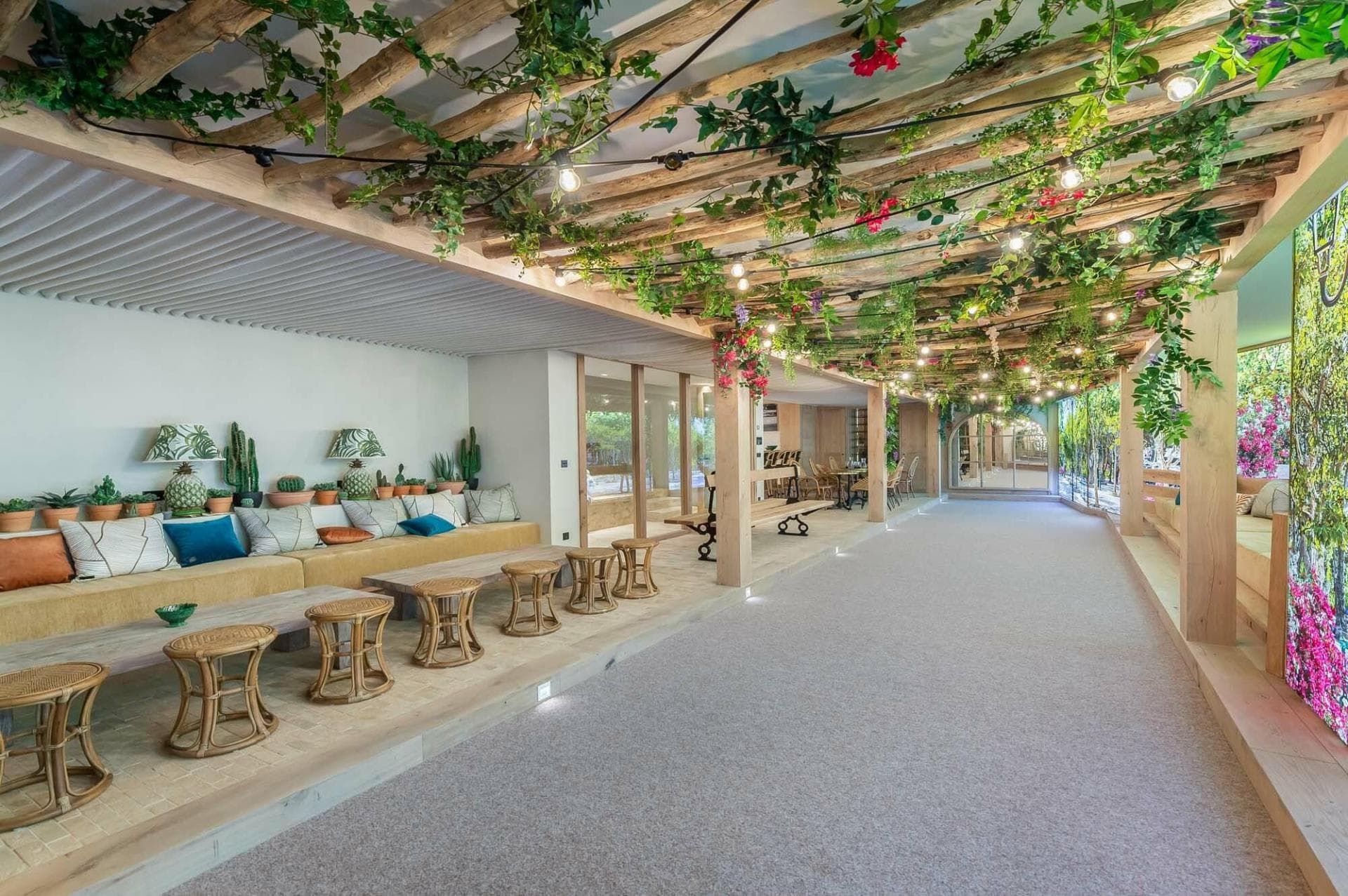 Indoor pétanque court with lounge seating and bistro tables