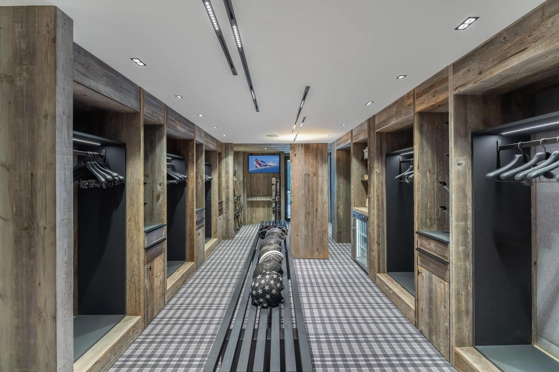 Ski room with hanging space and benches