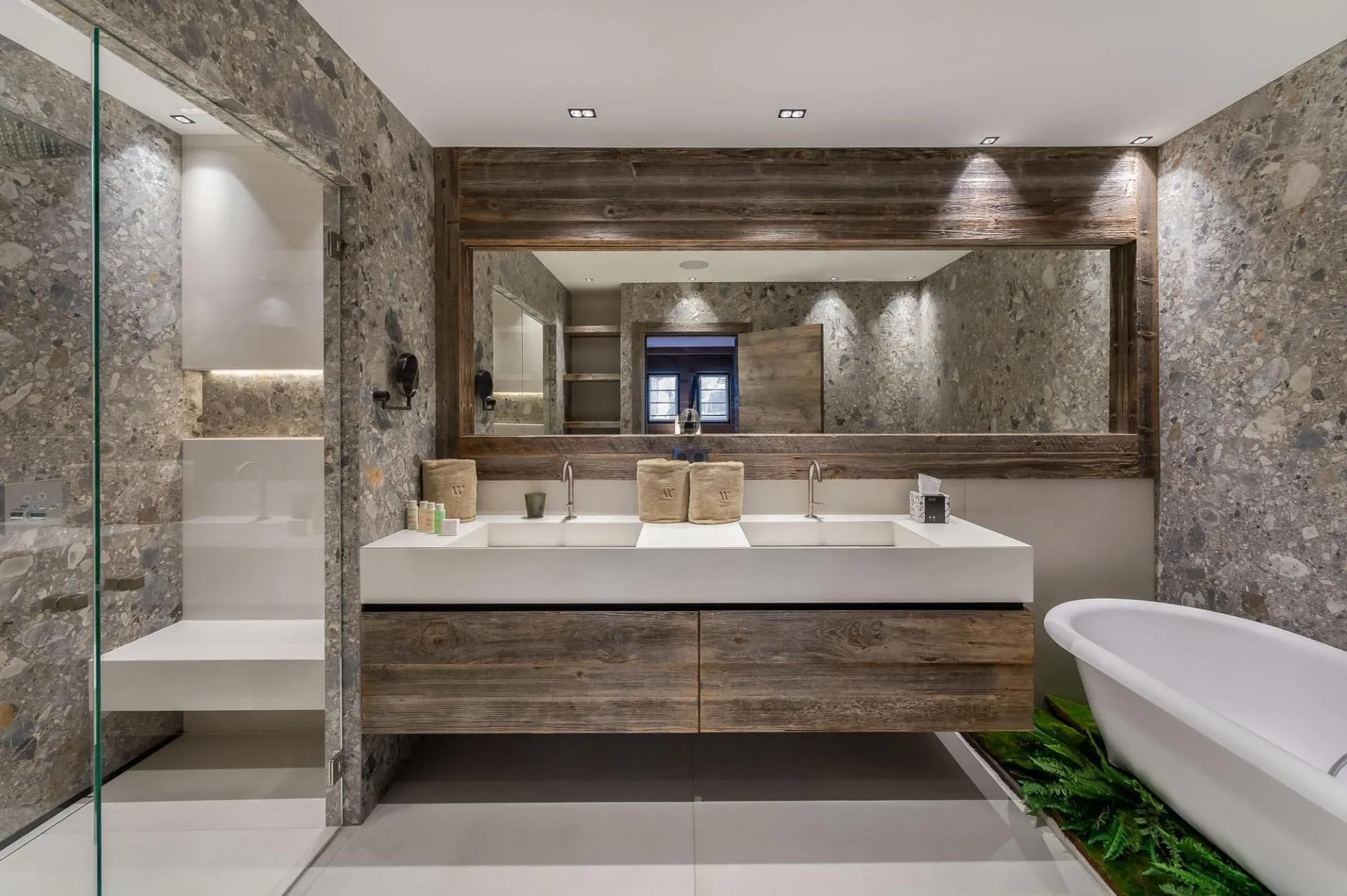 Bathroom with bathtub and double basins