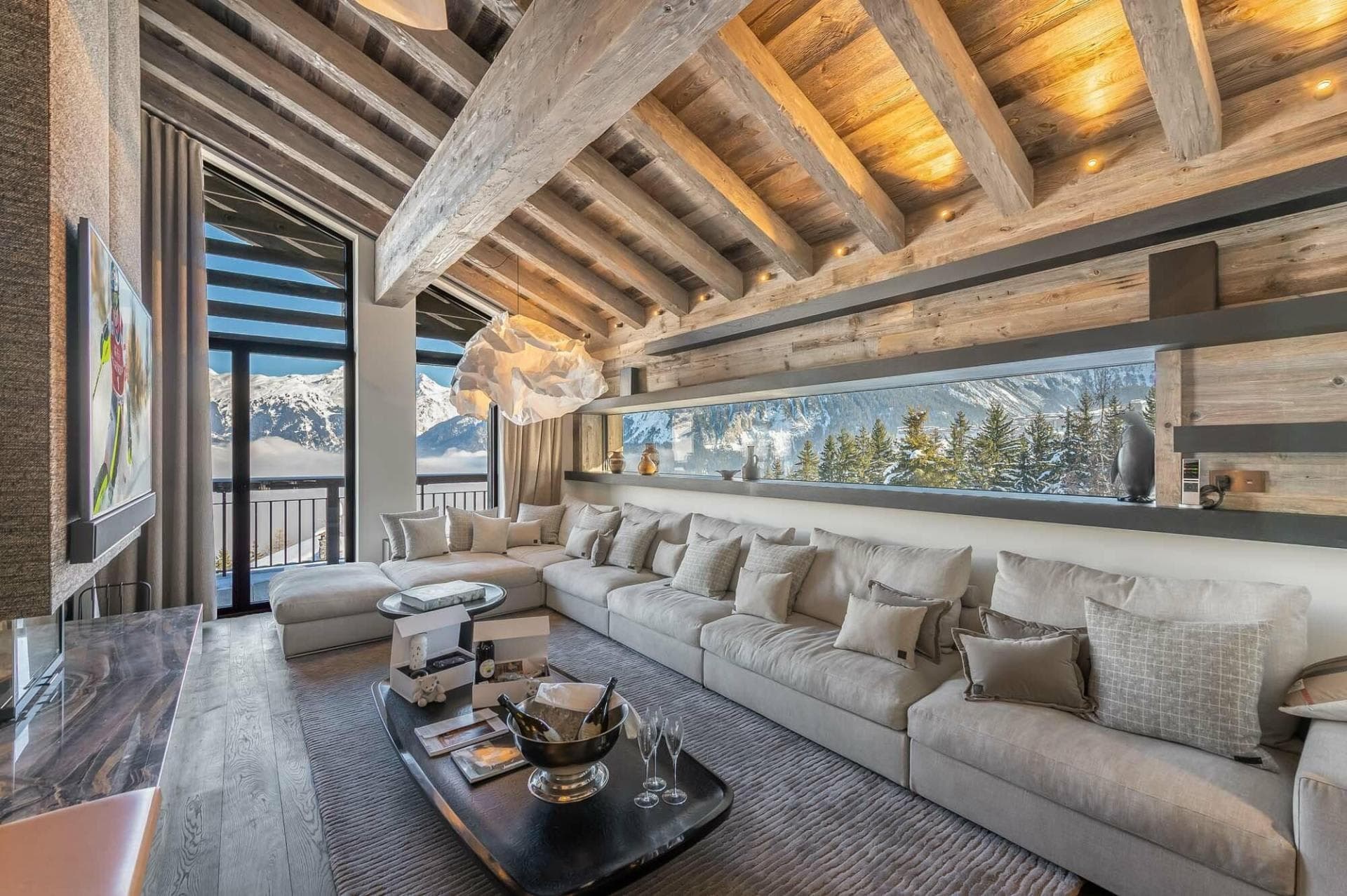 Living area with sectional seating and a mountain-view window