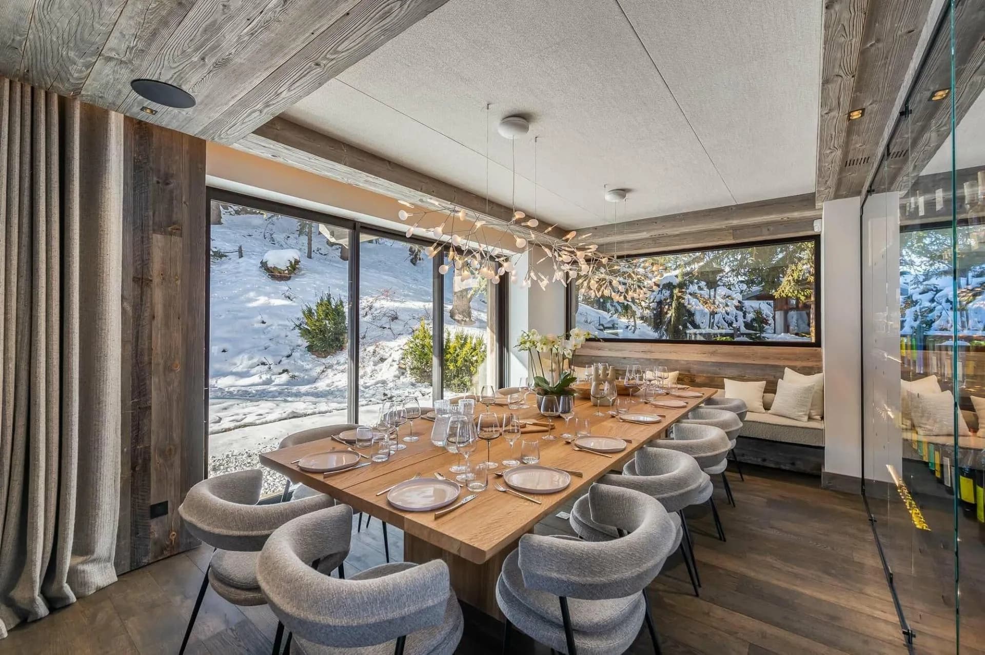 Dining table beside broad windows