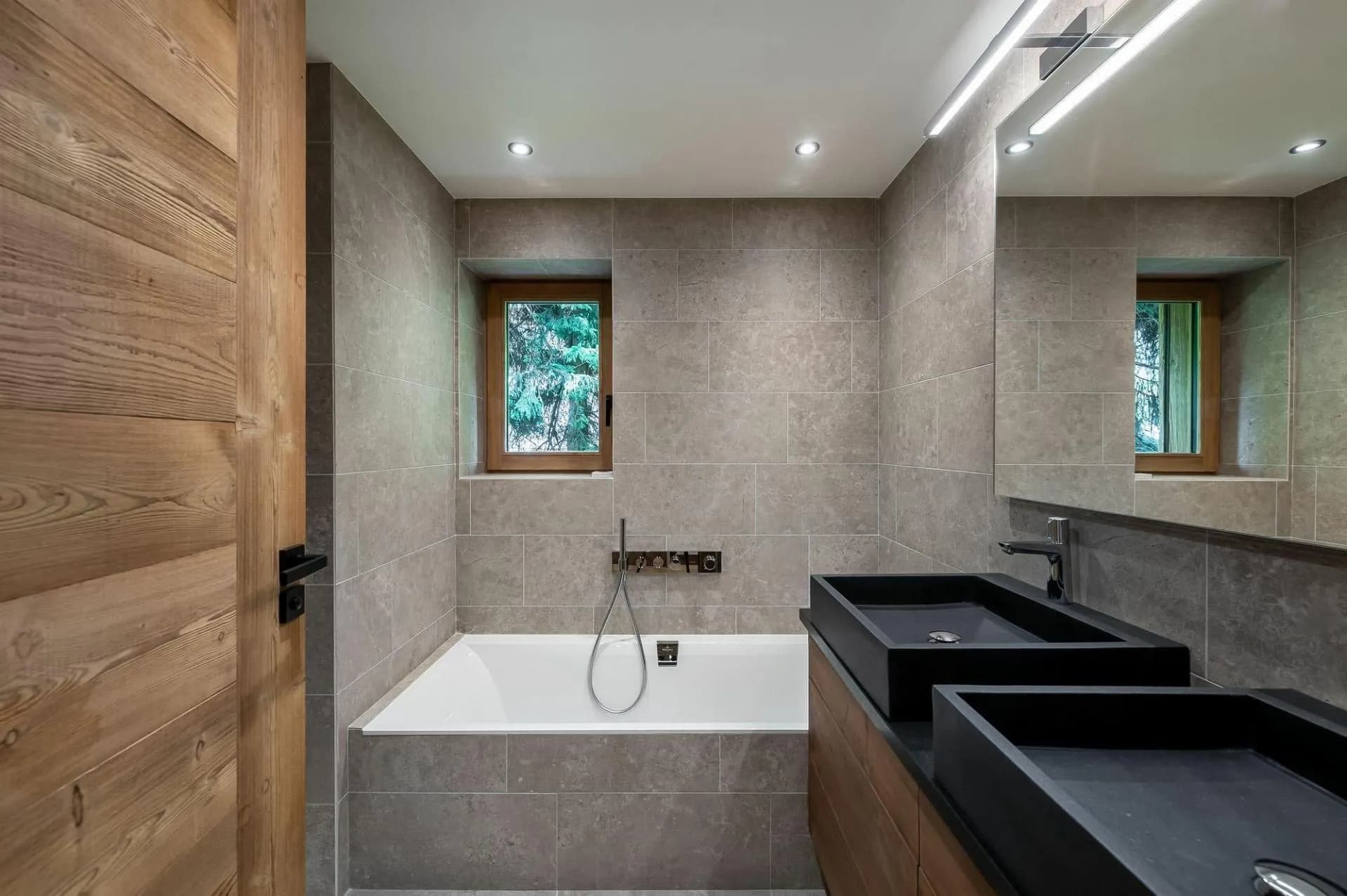 Bathroom with bathtub and double vanity