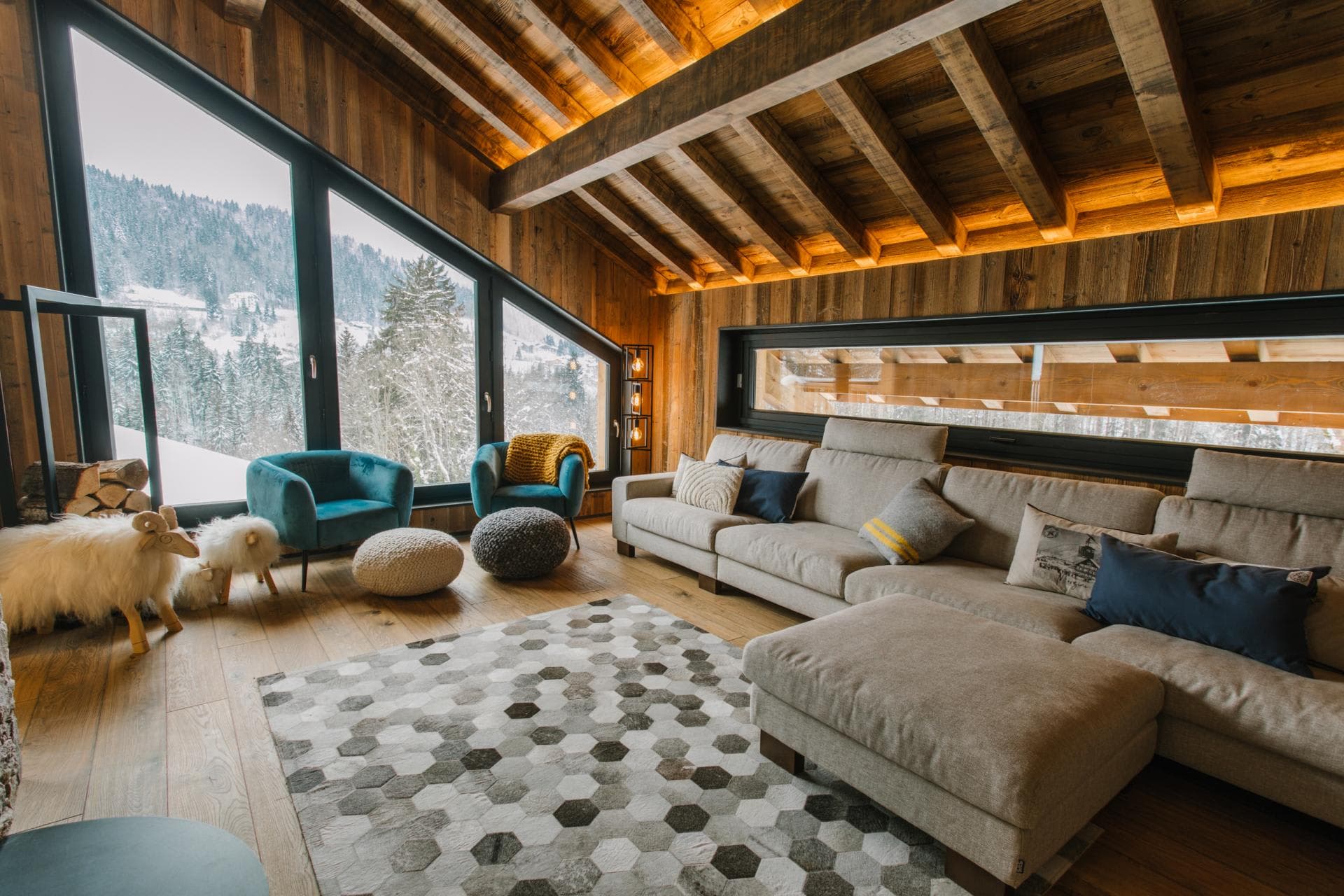 Living area with sectional seating and floor-to-ceiling mountain views