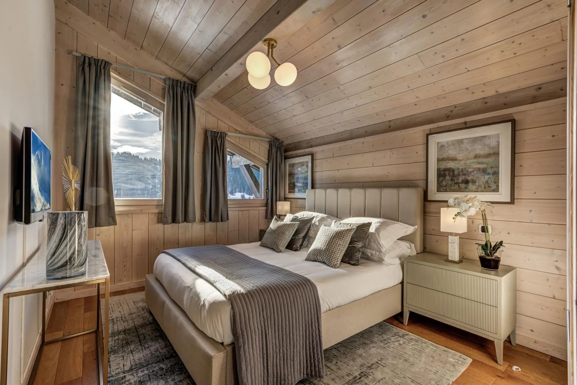 Bedroom with king bed, timber-clad walls, and mountain views
