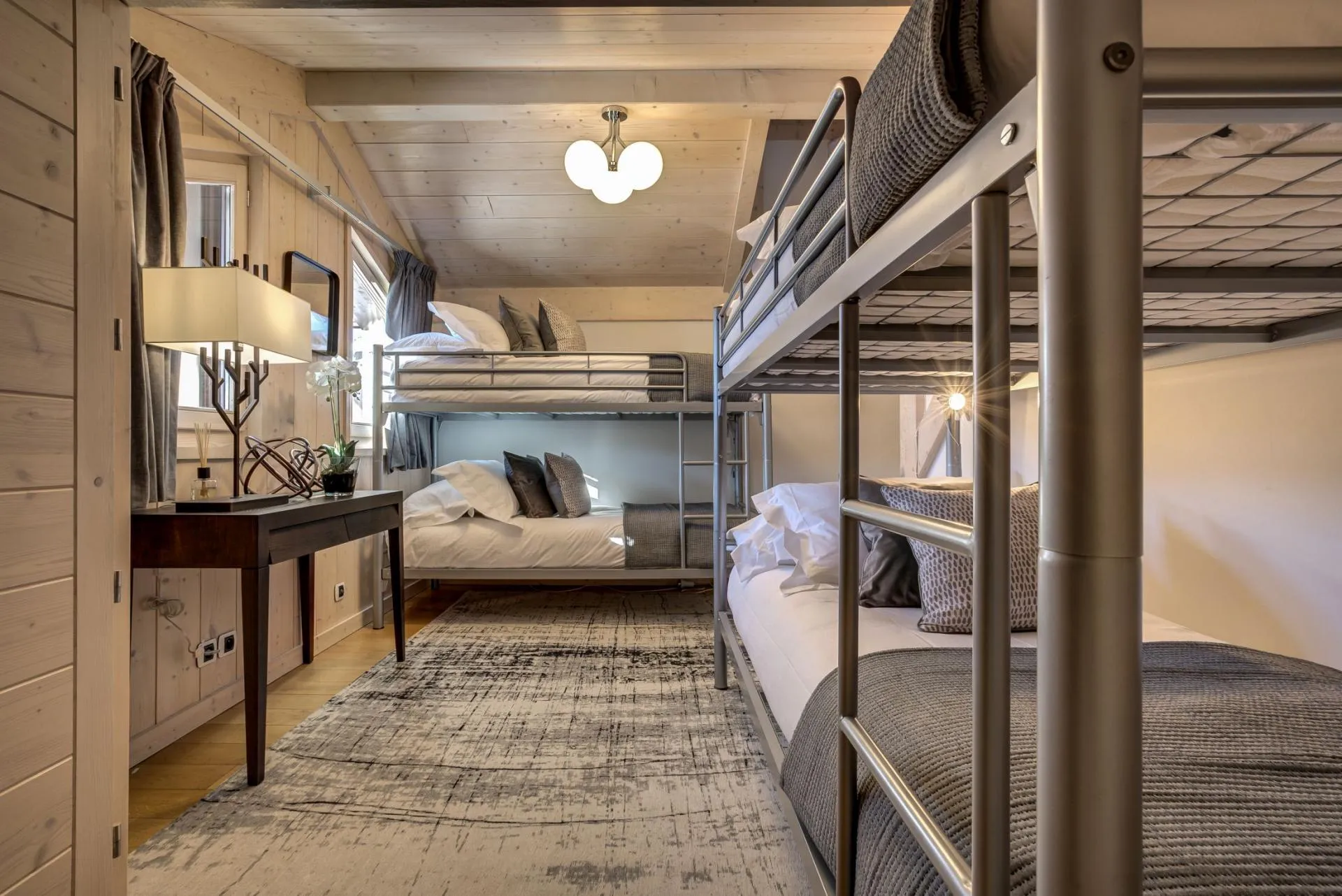 Bunk room with two metal bunk bed sets sleeping four