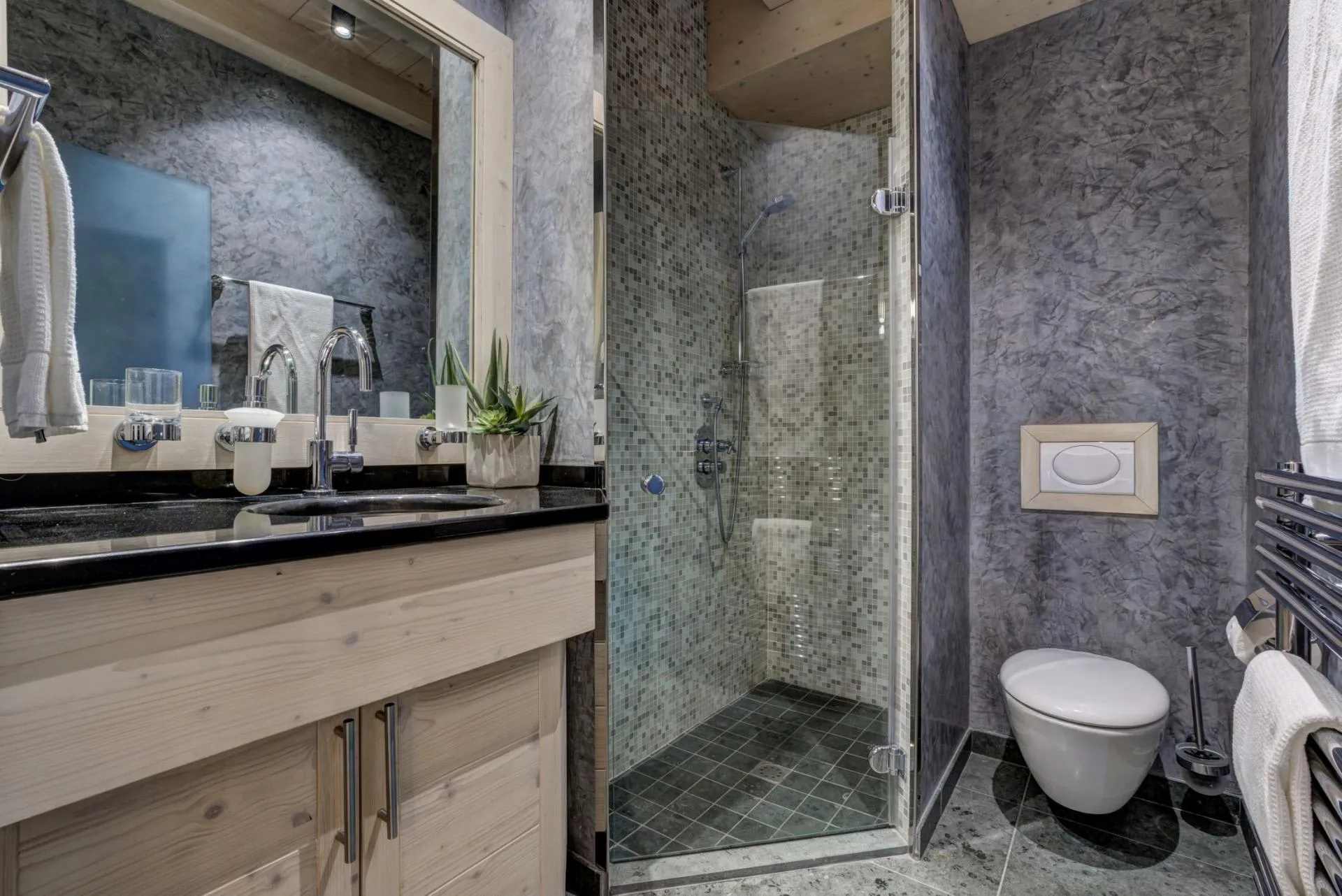 Walk-in shower with mosaic tile and heated towel rack