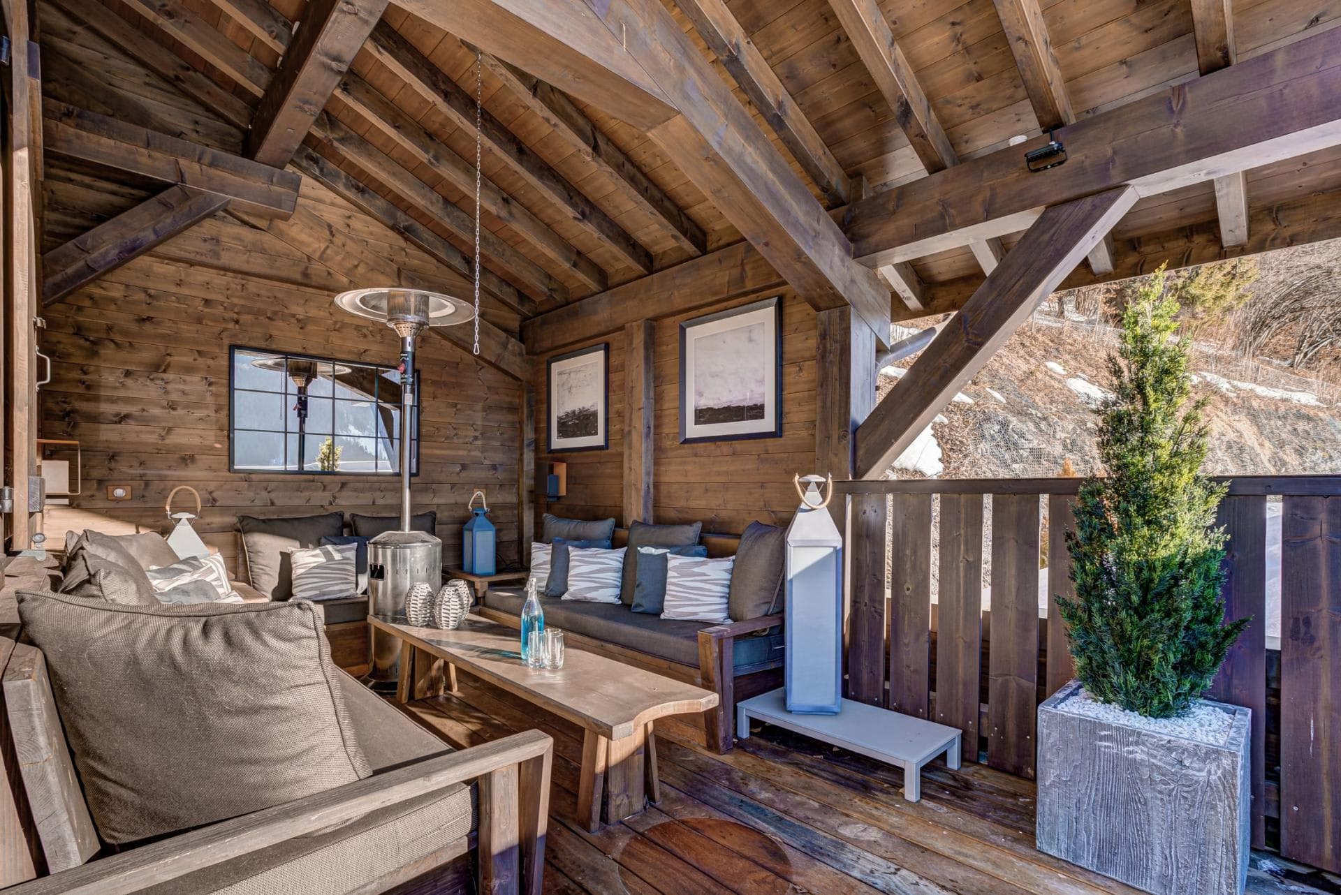 Covered terrace with patio heater and cushioned bench seating