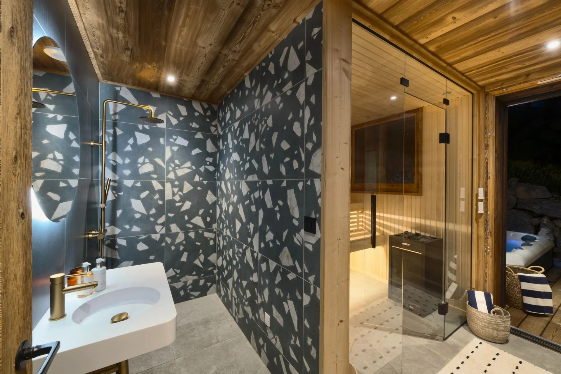 Wellness shower and glass-fronted sauna with outdoor access