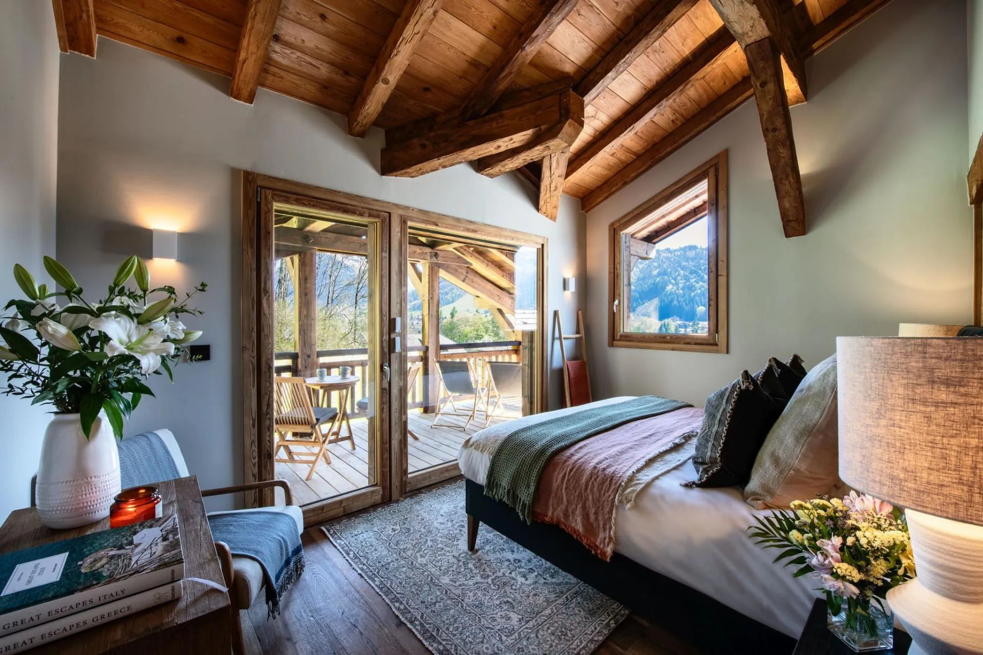 Bedroom opening onto a mountain-view balcony
