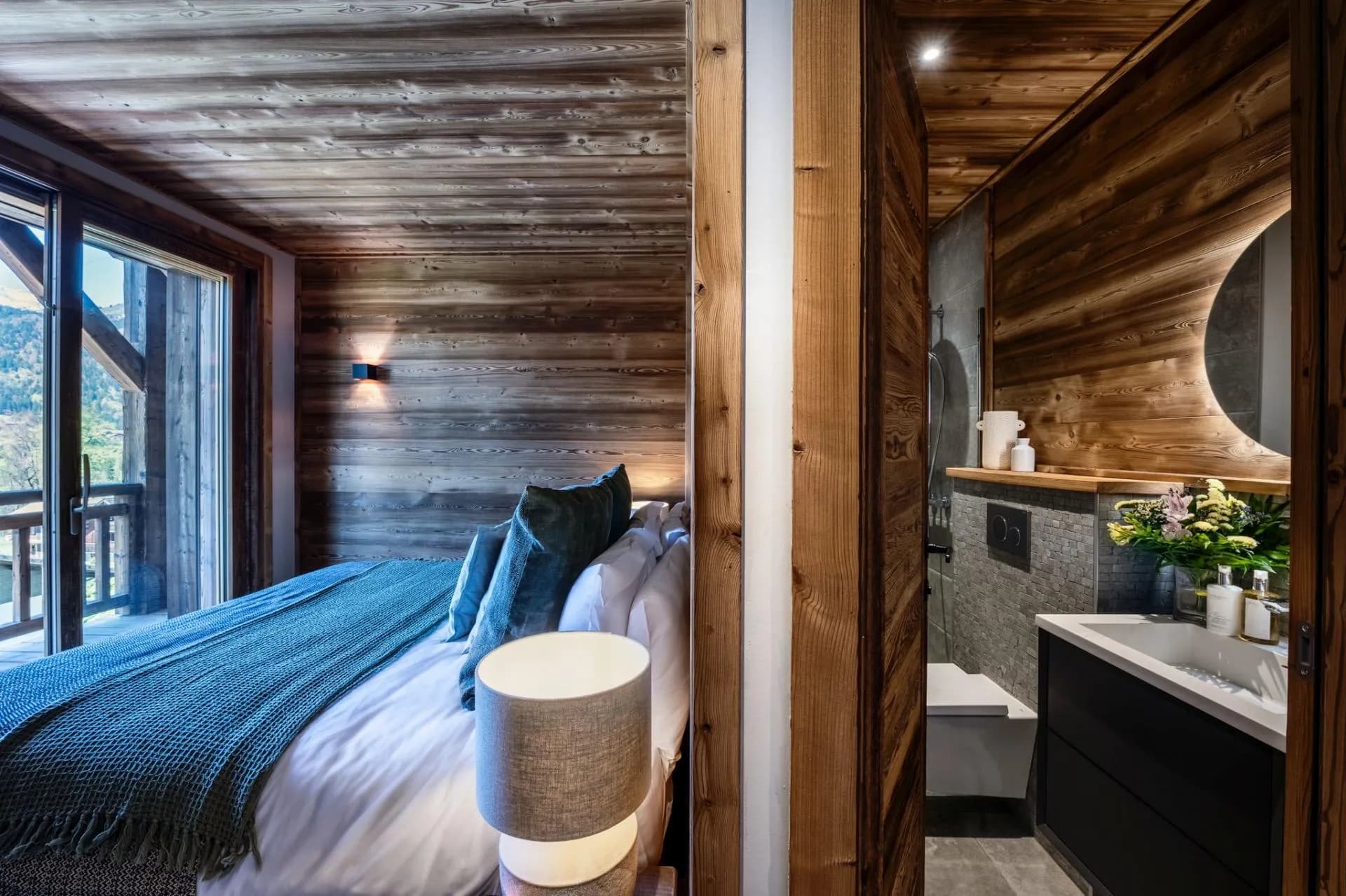 En-suite bathroom beside a bedroom with balcony access