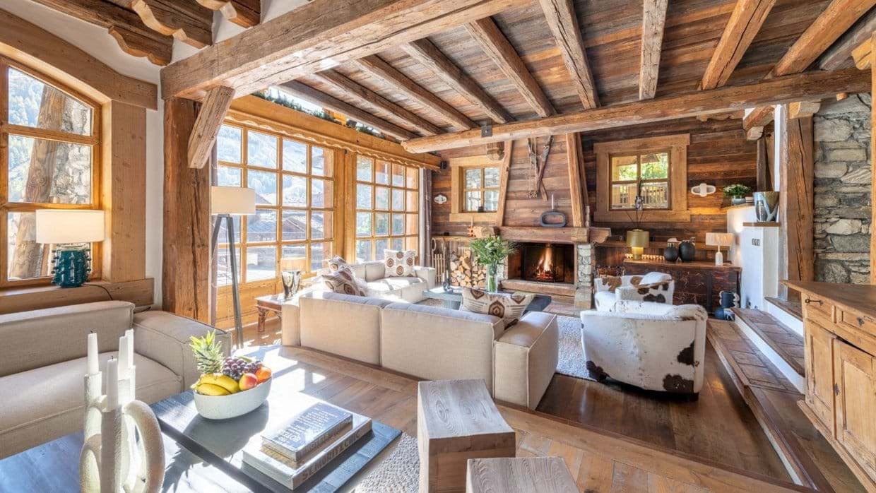 Living area with wood-burning fireplace and original timber beams