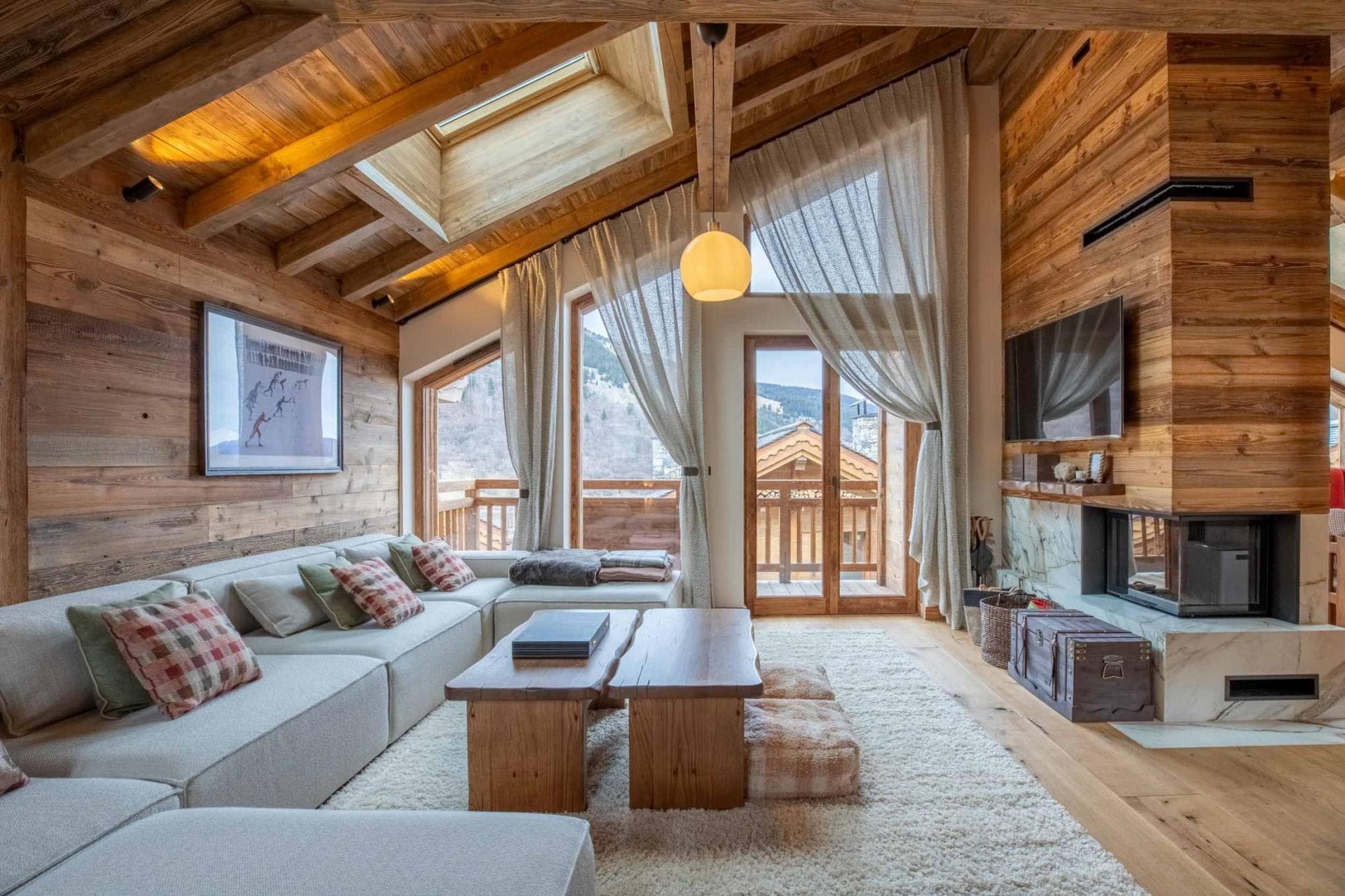 Living area with wood-burning fireplace and balcony access