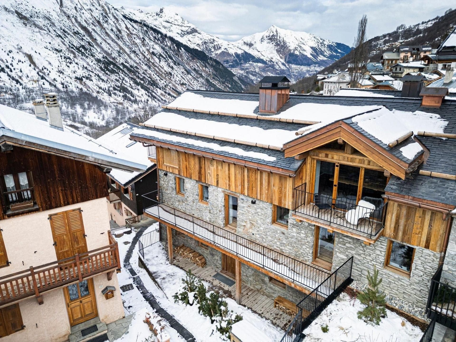 Stone and timber chalet with multi-level balconies and mountain views