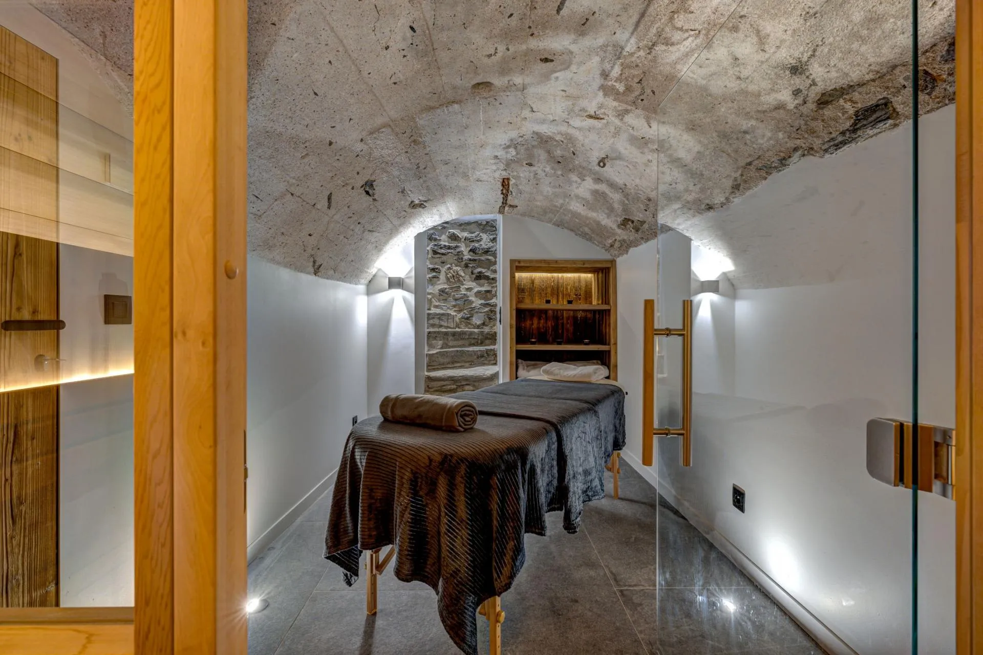 Treatment table beneath stone vault beside sauna