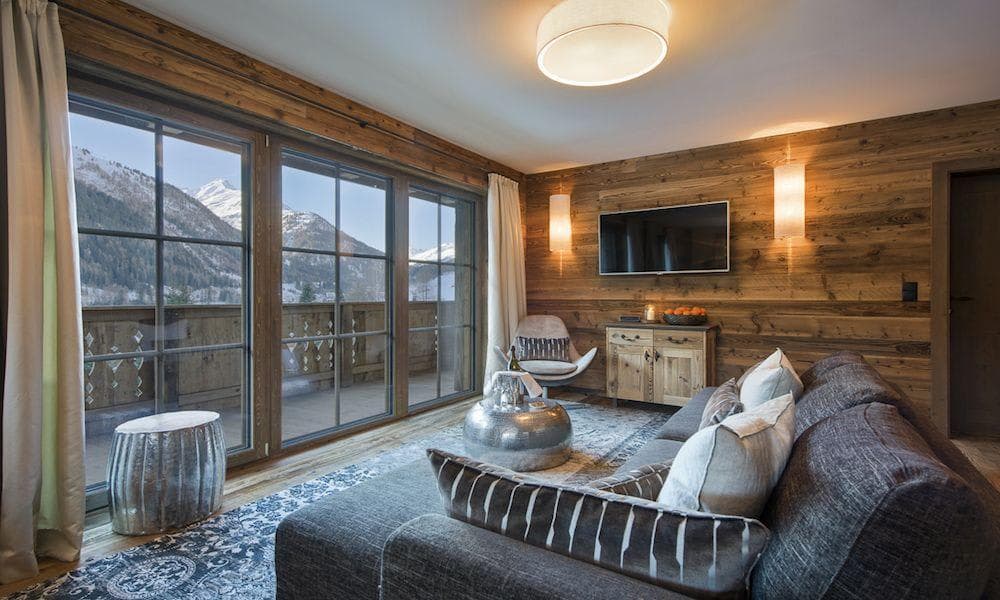 Living area with floor-to-ceiling windows and private balcony access