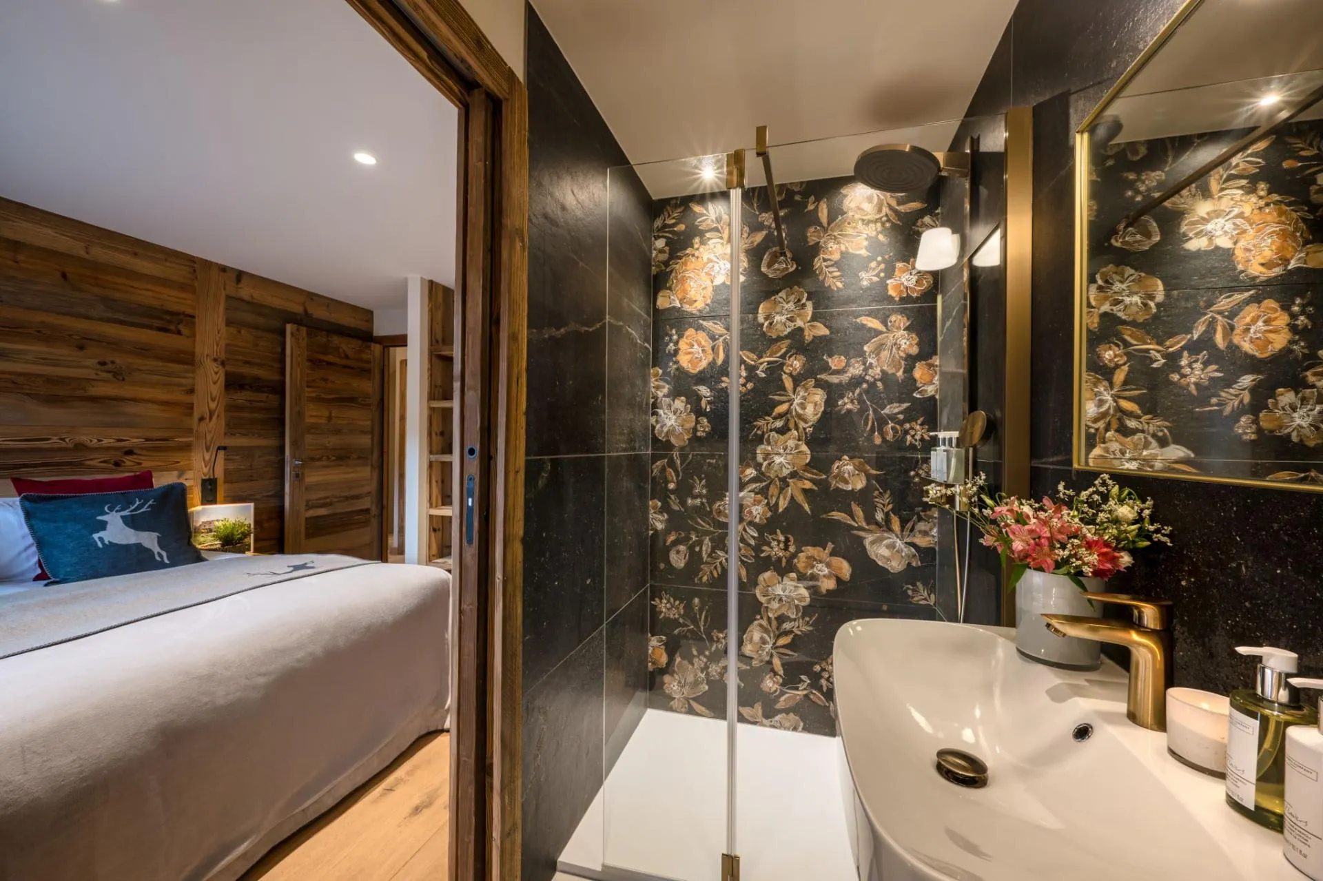En-suite shower room with a rainfall shower and floral tile