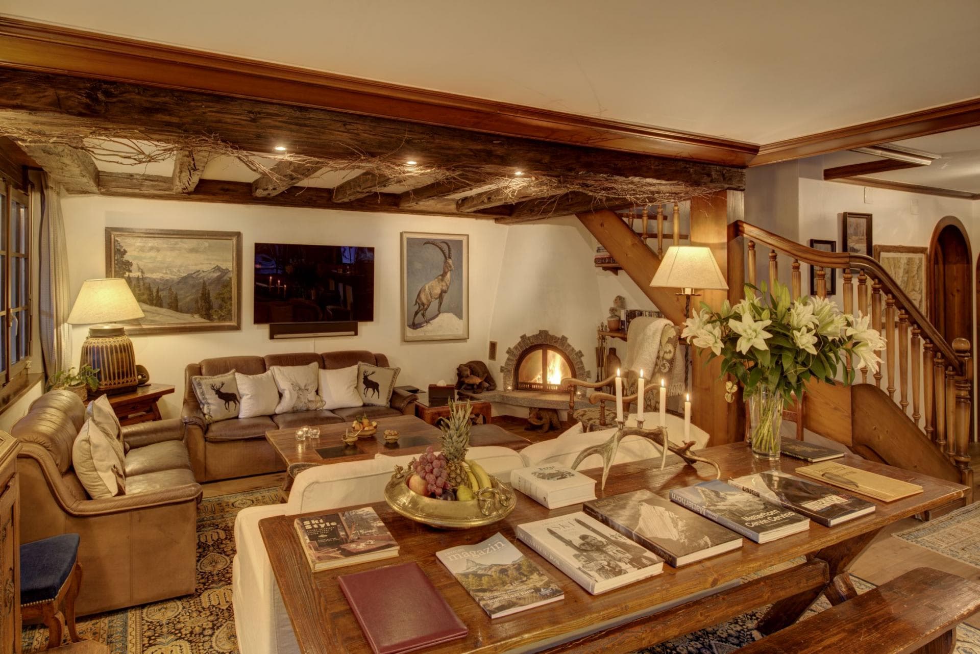 Living area with wood-burning fireplace and original timber beams