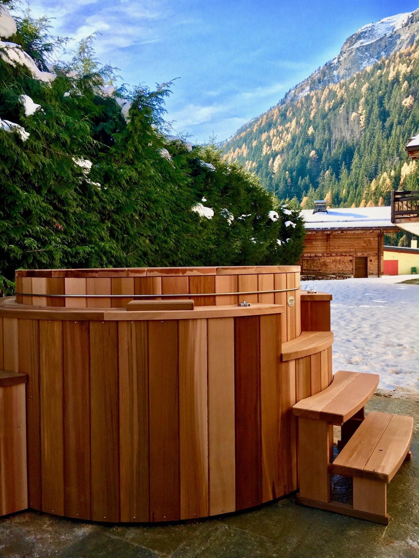 Cedar hot tub with integrated steps and alpine views