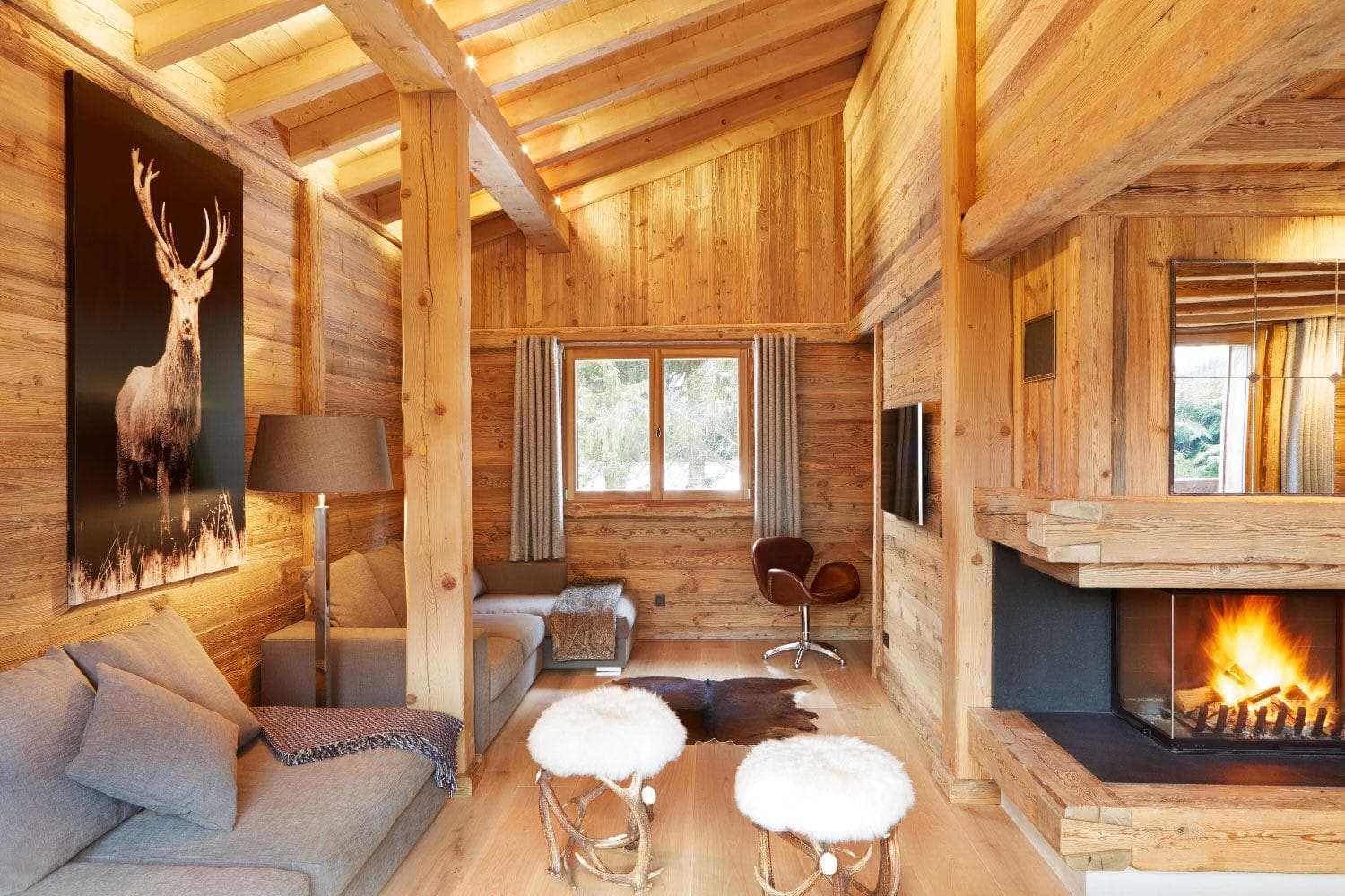 Living area with glass-enclosed fireplace and vaulted timber ceilings