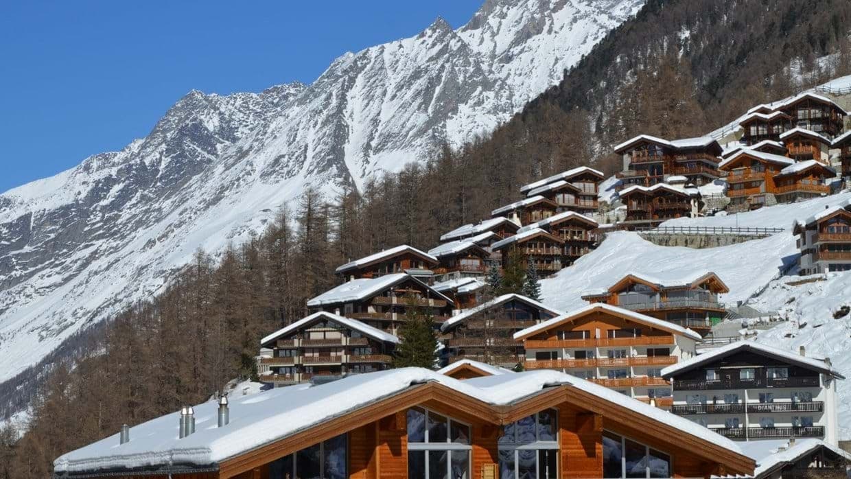 Hillside chalets with private balconies and panoramic mountain peak views