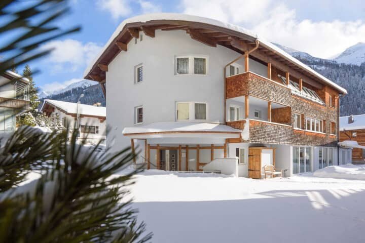 Chalet exterior featuring private balconies and immediate access to snowy terrain