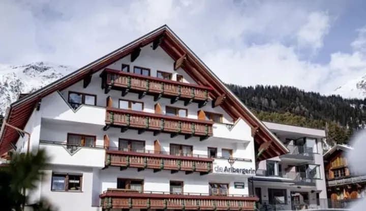 Chalet exterior with private balconies and mountain backdrop