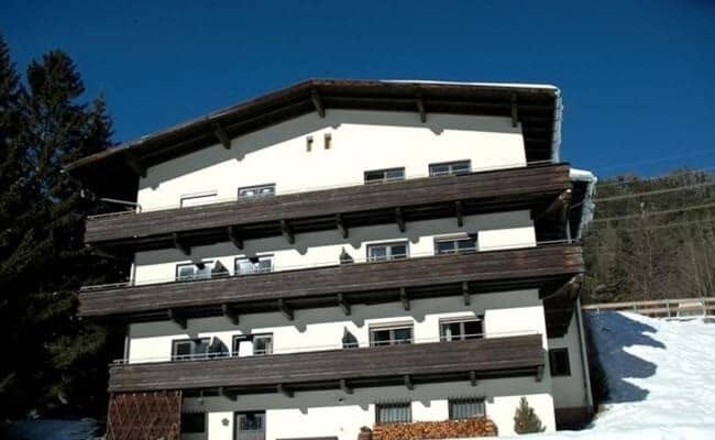 Chalet exterior with three levels of private balconies and slope-side access
