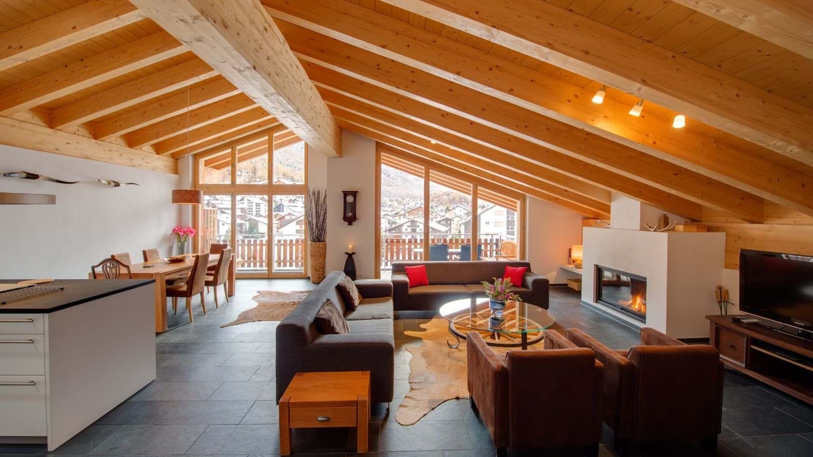 Open-plan living area with wood-beam ceilings and gas fireplace