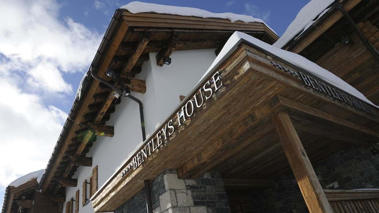 Chalet entrance with wood timber framing and 4-star rating signage
