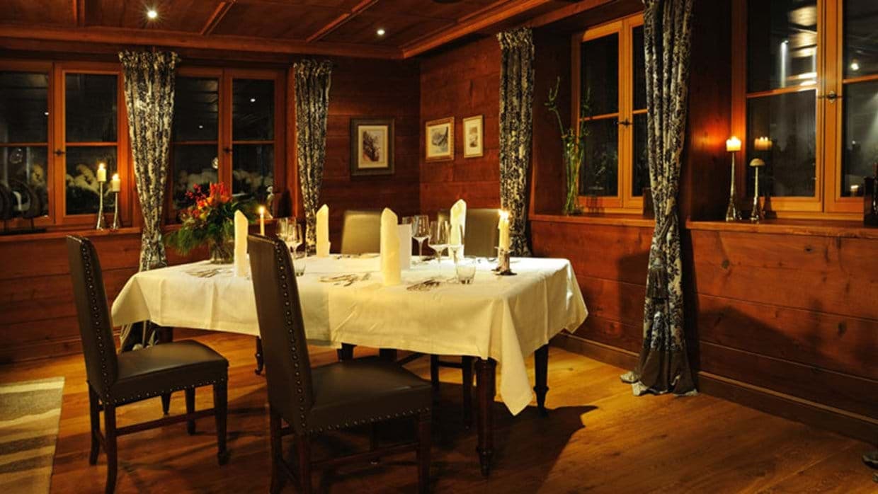 Dining room with seating for 6 and wood-paneled walls