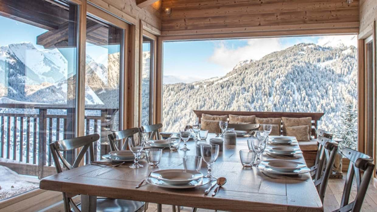 Dining area seating 10 with panoramic mountain views and balcony access