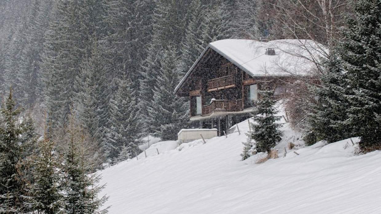 Ski-in, ski-out timber chalet with dual balconies and forest surroundings