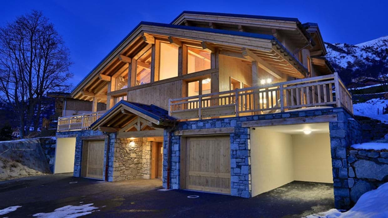 Chalet exterior with four-car garage and wrap-around balcony