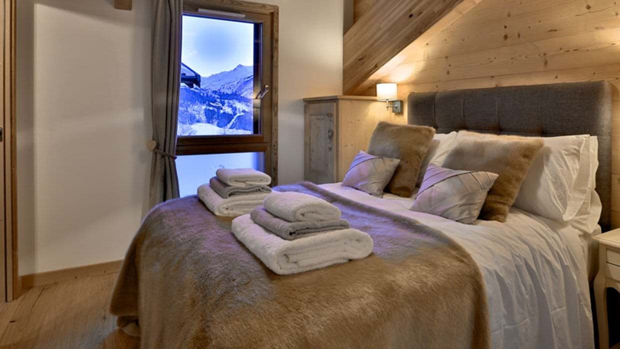 Bedroom with king bed and snow-covered mountain views