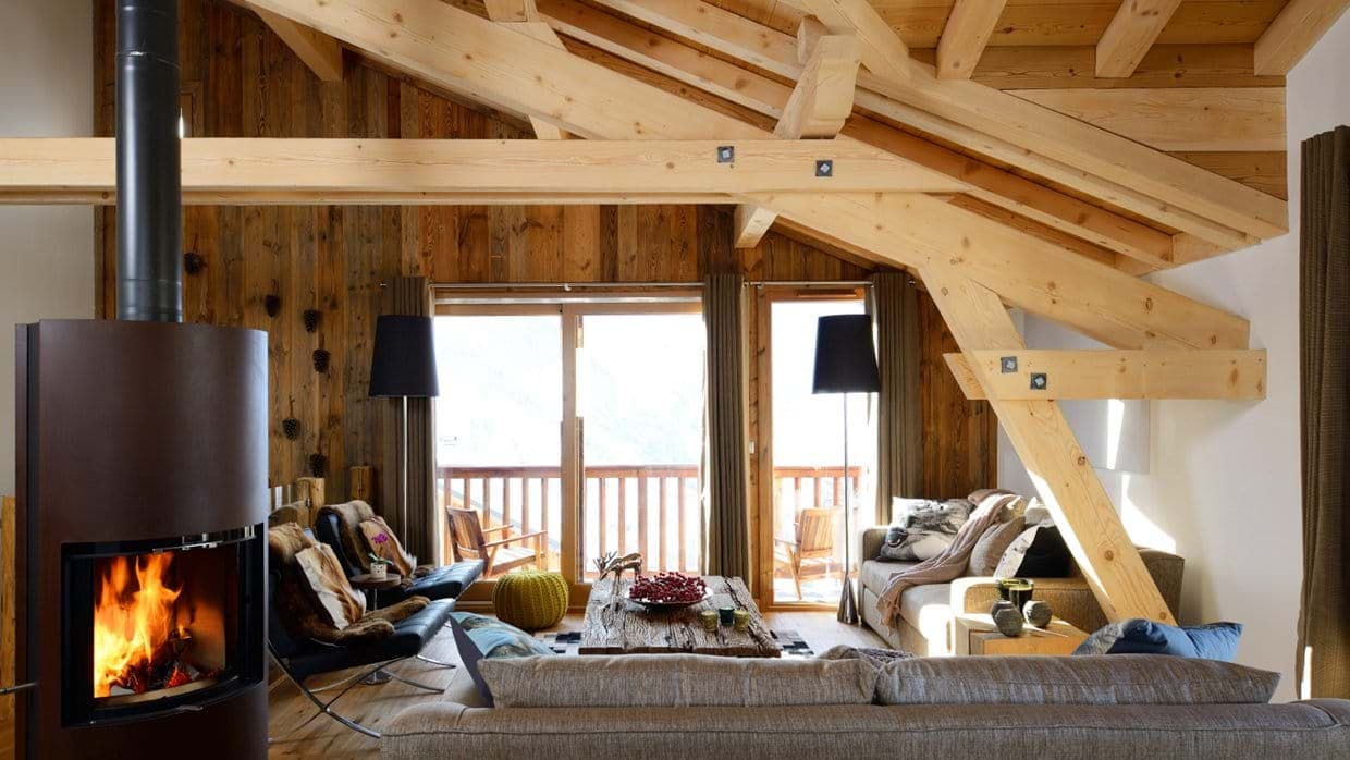 Living room with wood-burning stove and exposed timber beams