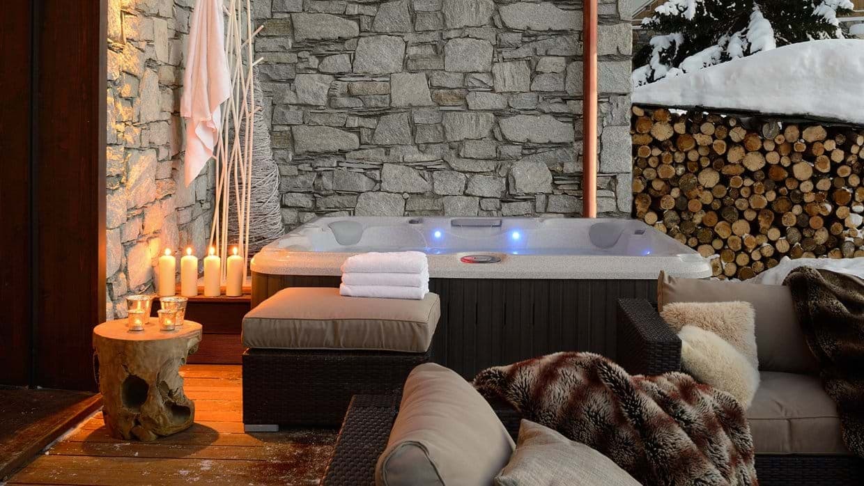 Outdoor hot tub seats 4 with adjacent lounge seating