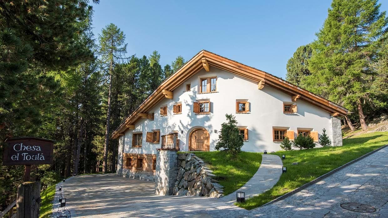 Chalet exterior with stone driveway and private wooded surroundings