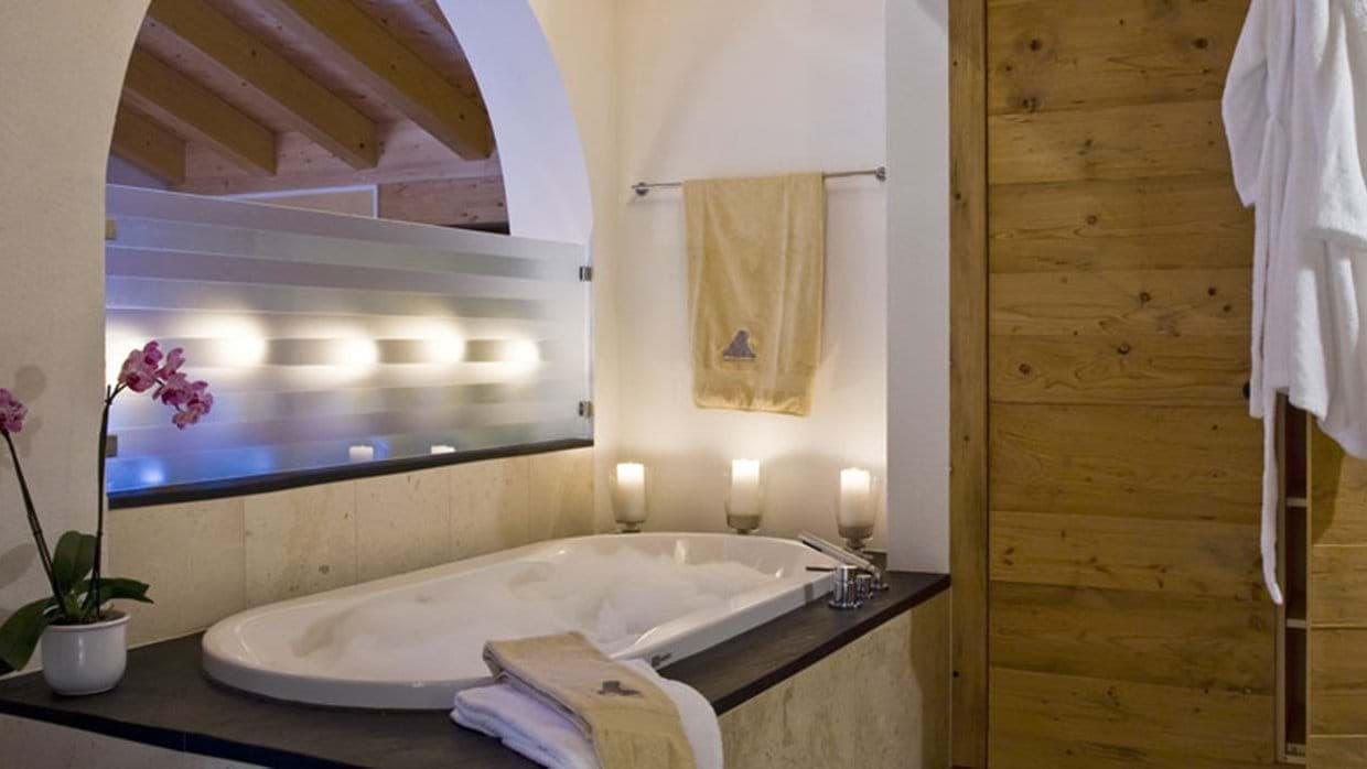 Bathroom with soaking tub and privacy glass partition