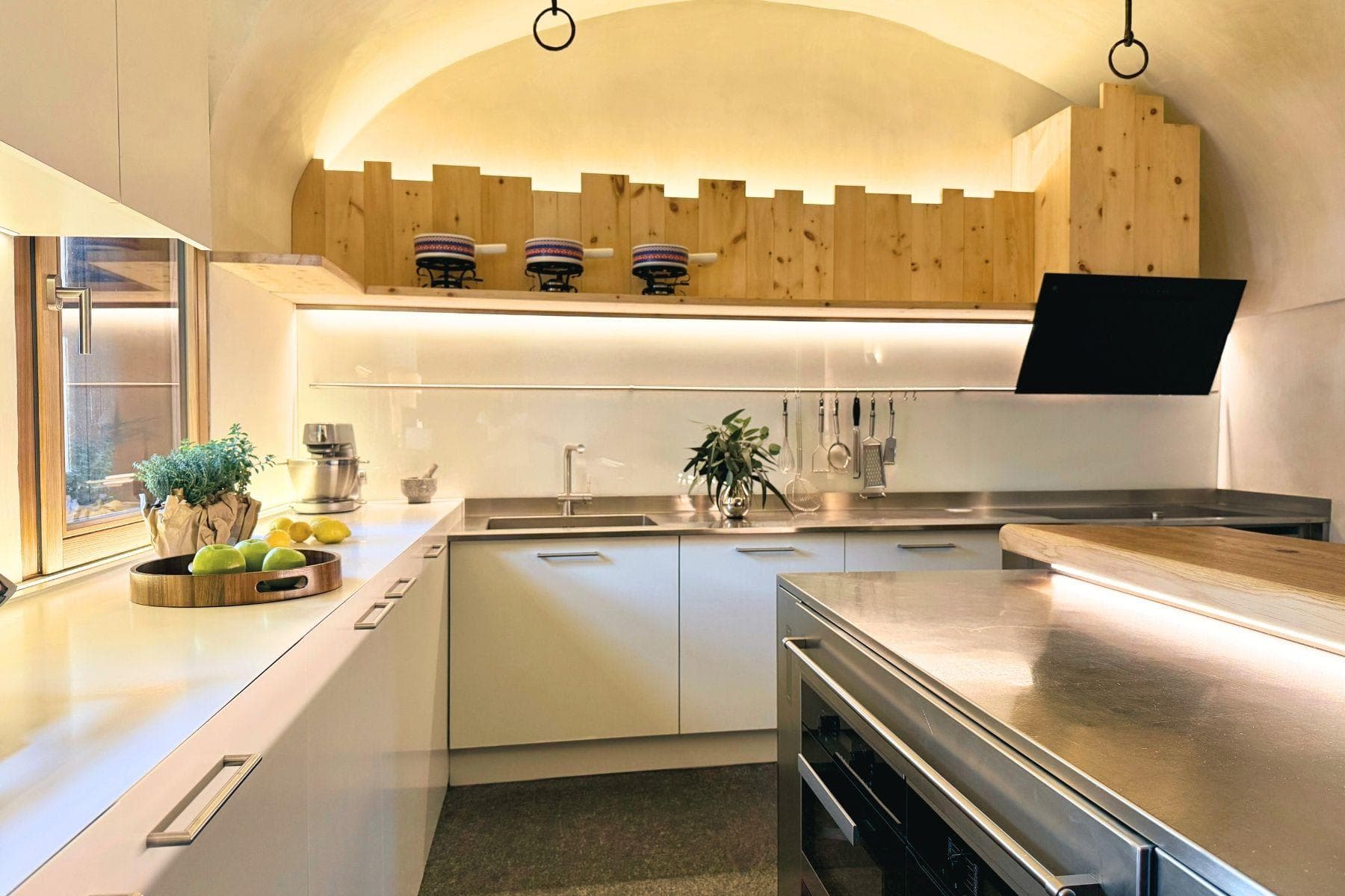 Kitchen with stainless steel counters and vaulted ceiling; induction cooktop included