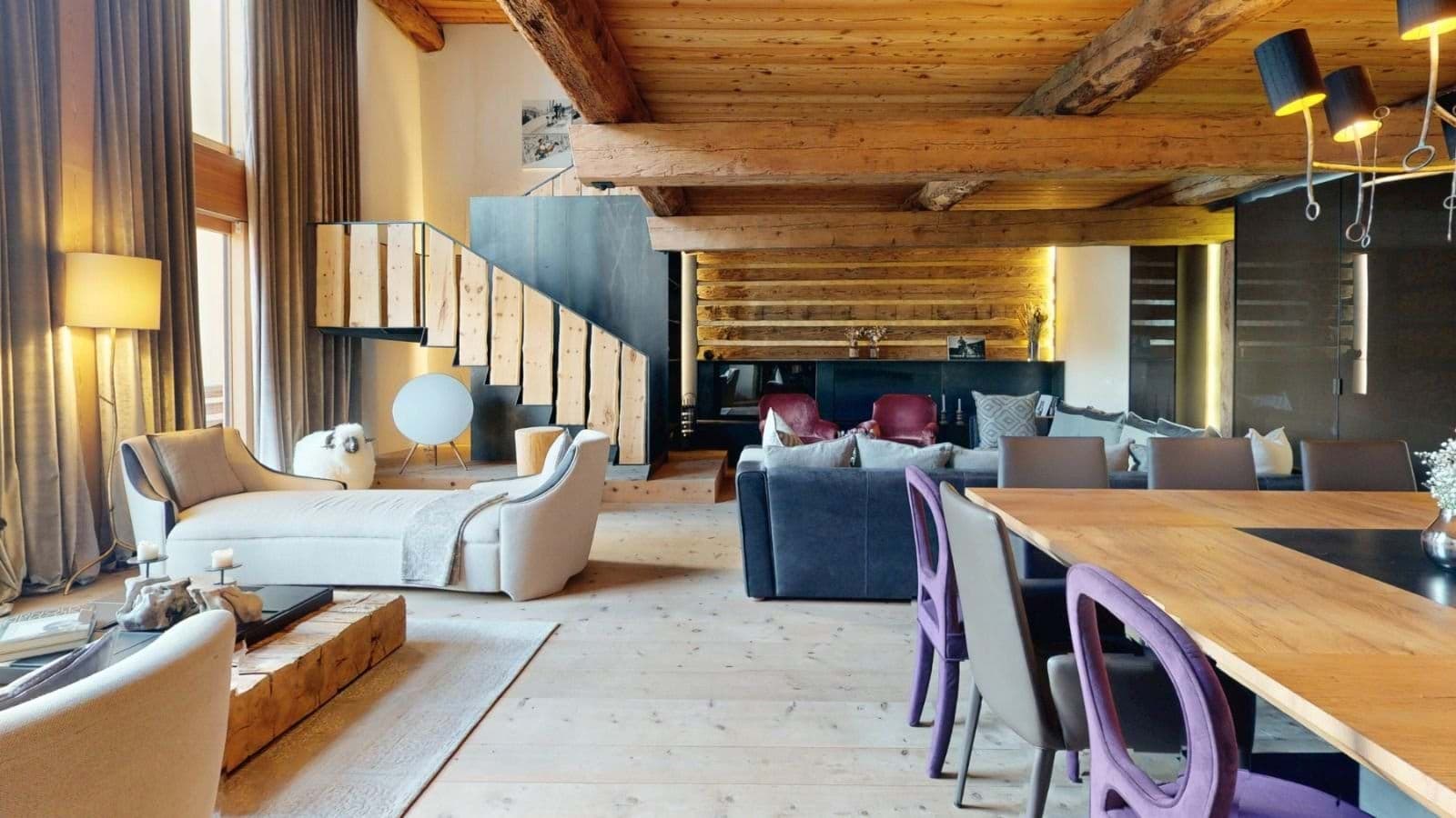 Open-plan living area with vaulted timber ceilings and seating for 10