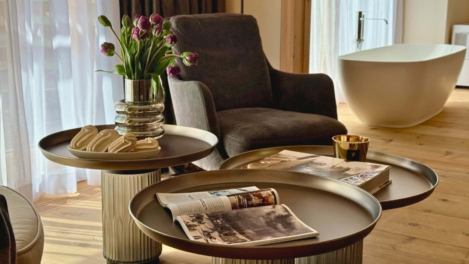 Primary suite seating area with soaking tub and hardwood floors