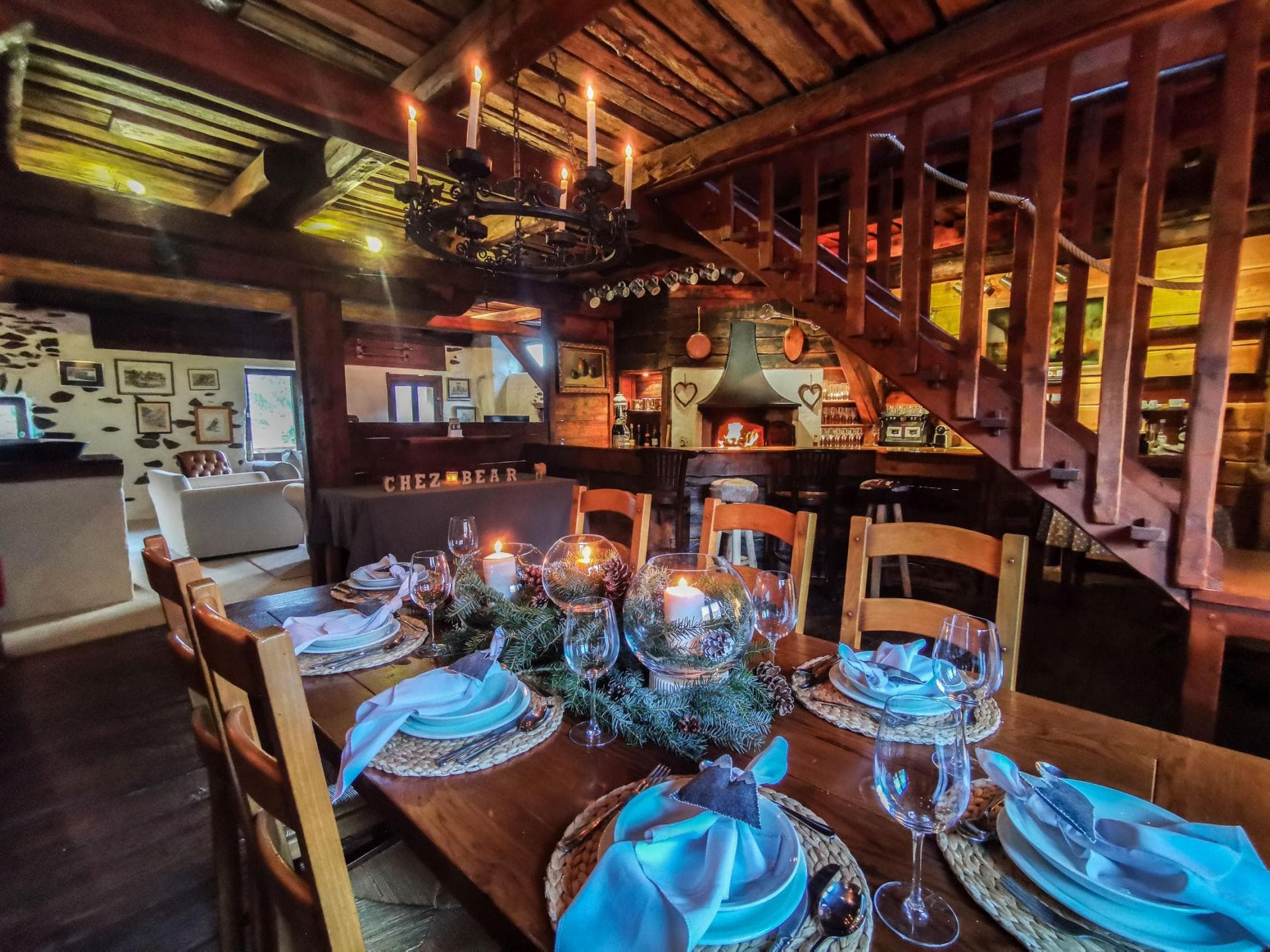 Dining area seats 8; features exposed timber beams and candle chandelier