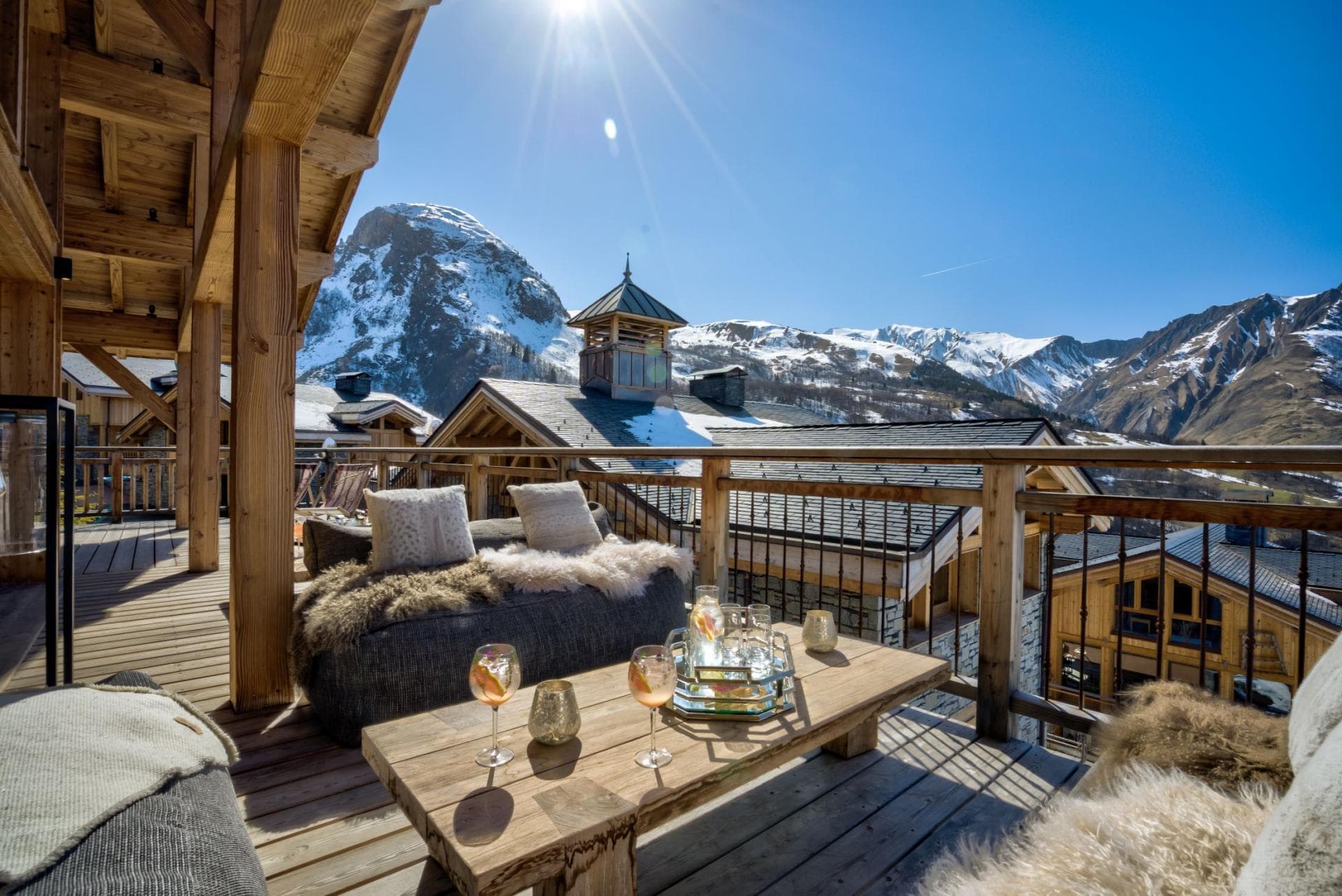Private balcony with lounge seating and panoramic Alpine mountain views