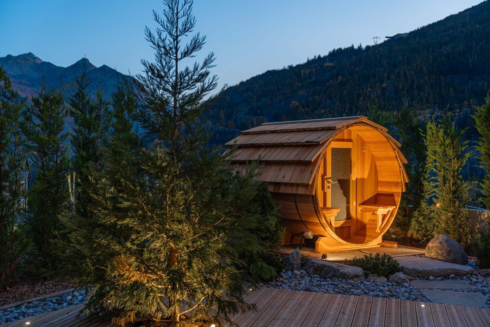 Outdoor barrel sauna with mountain views and wood-shingle roof
