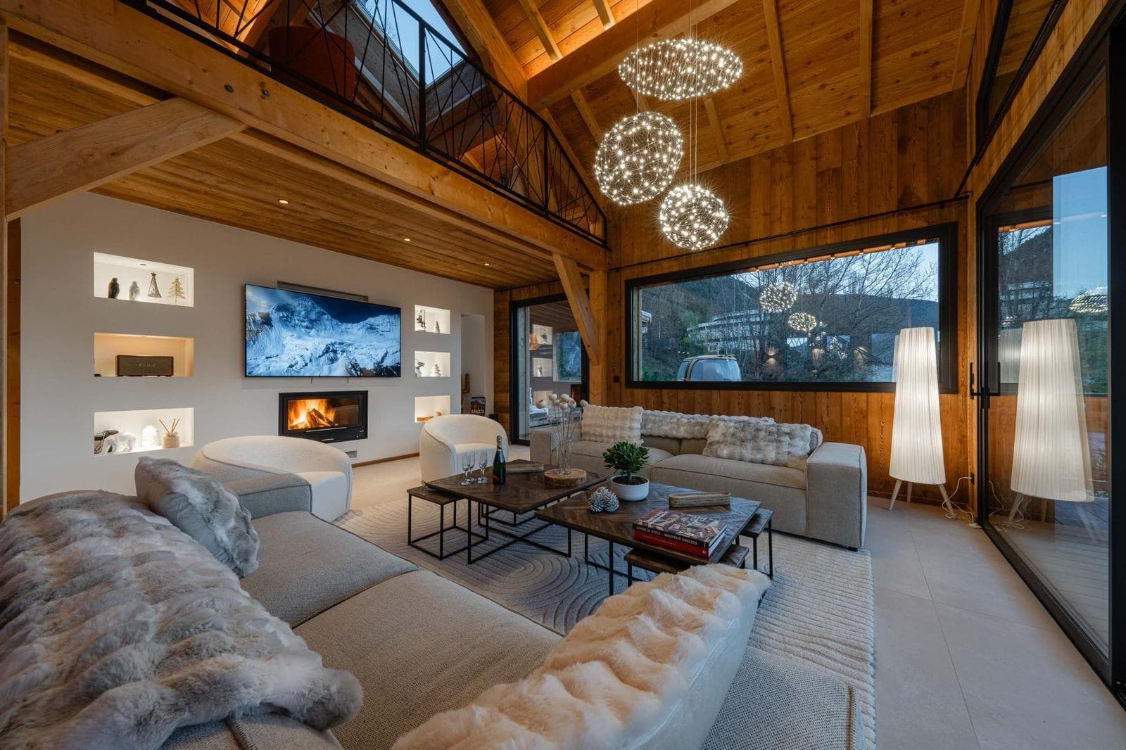 Living area with wood-burning fireplace and double-height ceilings