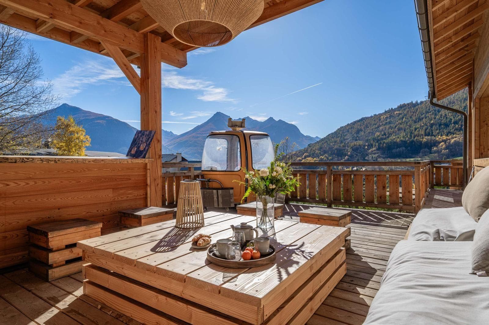 Covered timber deck with lounge seating and converted gondola sauna
