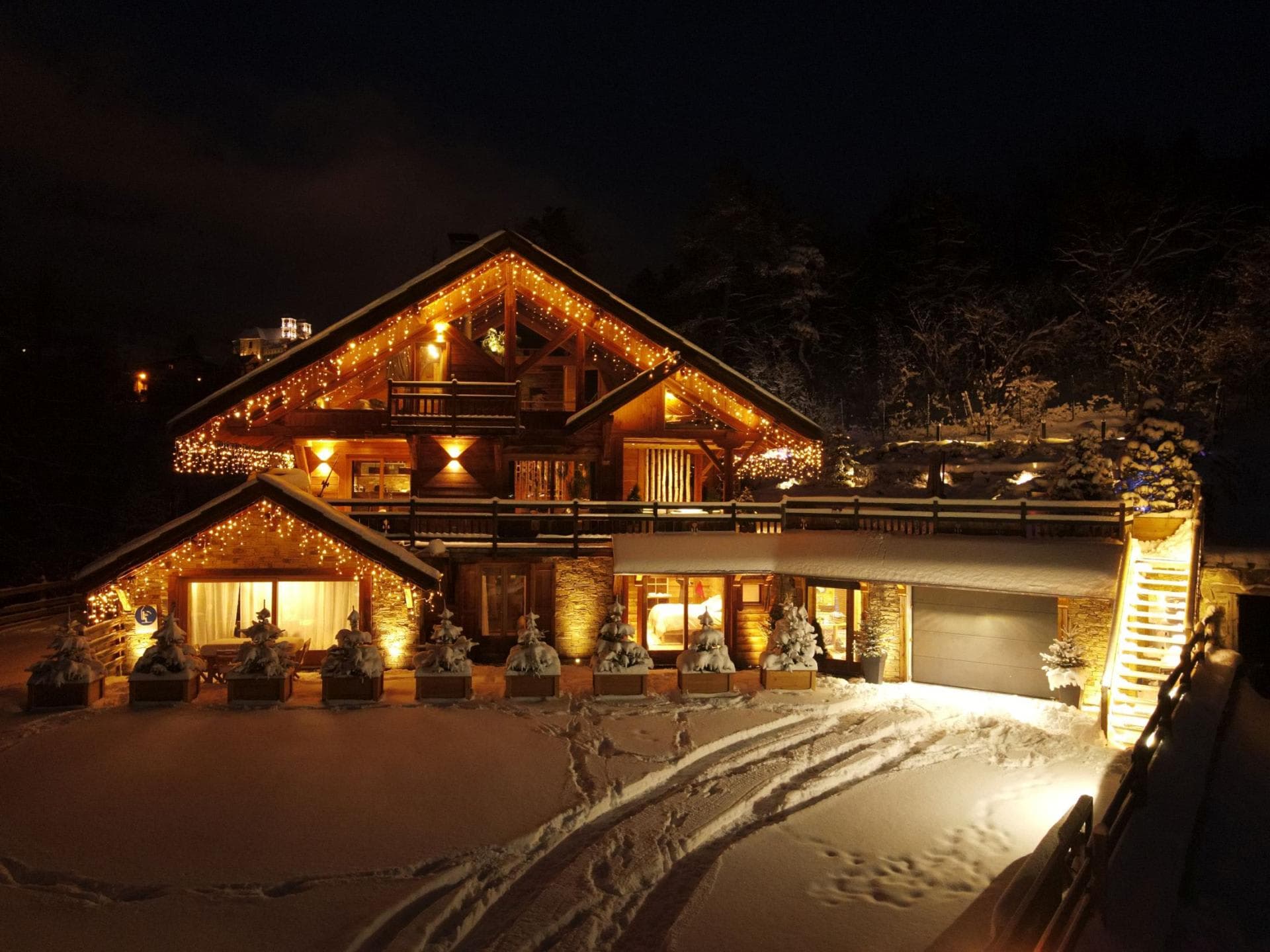 Chalet exterior with heated driveway, private garage, and wraparound balcony