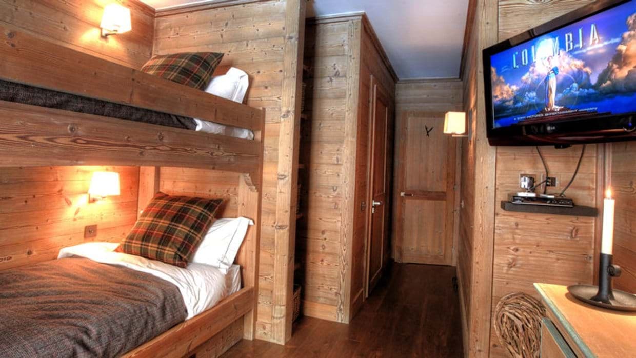 Bunk room with two twin beds and wall-mounted TV