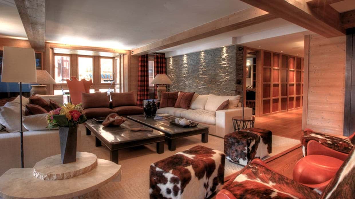 Living area with sofa seating for 10 and natural stone feature wall