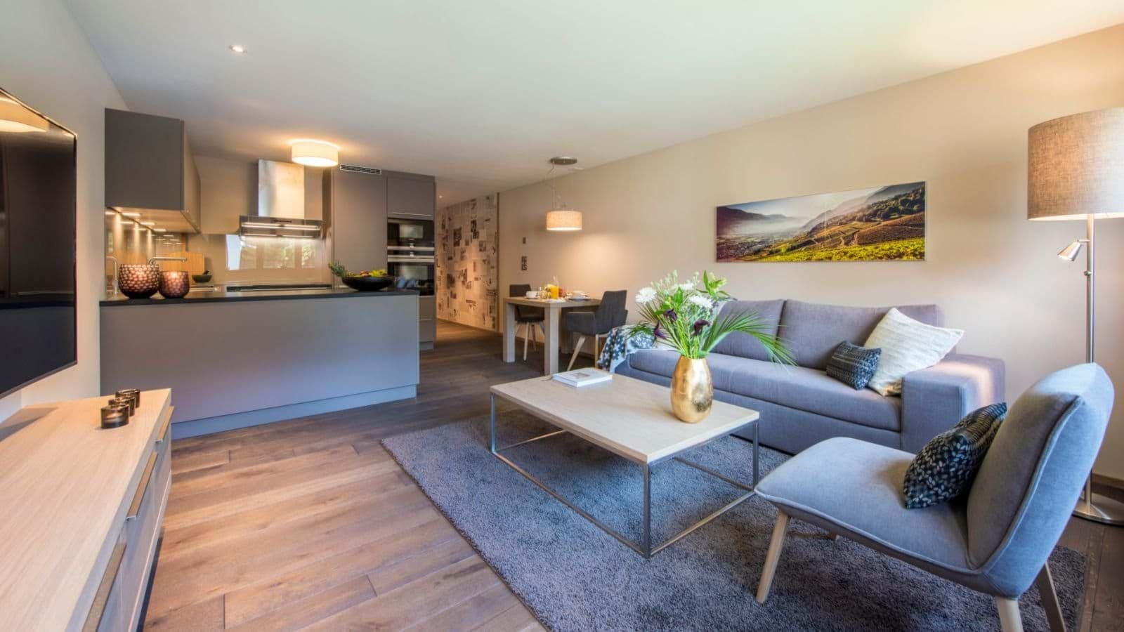 Open-plan living area with integrated kitchen and four-person dining table